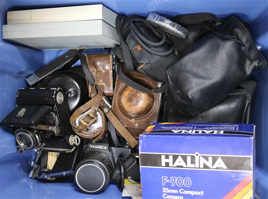 A box of assorted cameras and equipment